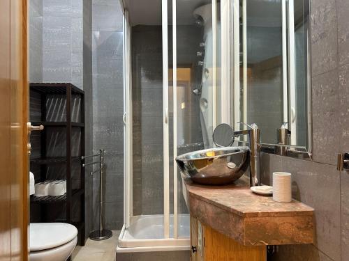 a bathroom with a bowl sink and a toilet at Premium Flat at Ajuda/Belém with Balcony, Parking! in Lisbon