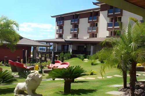 a resort with a yard with palm trees and a building at OZPED Flats Particulares Edifício Life Resort in Brasilia