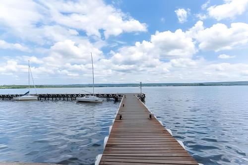 a dock with boats on a large body of water at OZPED Flats Particulares Edifício Life Resort in Brasilia