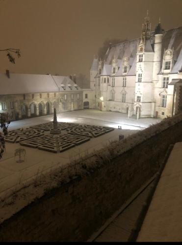 a large castle at night with snow on the ground at La collégiale in Beauvais