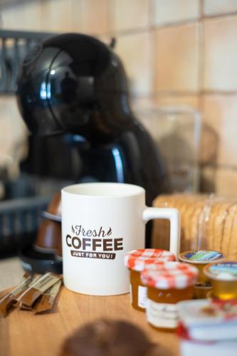 a coffee cup sitting on top of a table with cupcakes at GpxClrTheStreetFashionSuiteNW in Larisa