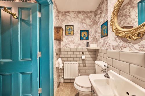 a bathroom with a toilet and a sink and a mirror at Jazz House in Derry Londonderry