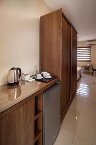 a kitchen with wooden cabinets and a counter top at Equipetrol Suites apart hotel in Santa Cruz de la Sierra