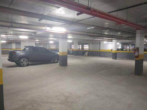 a parking garage with a black car parked in it at Rio De Janeiro Freguesia Jacarepaguá Lotf in Rio de Janeiro