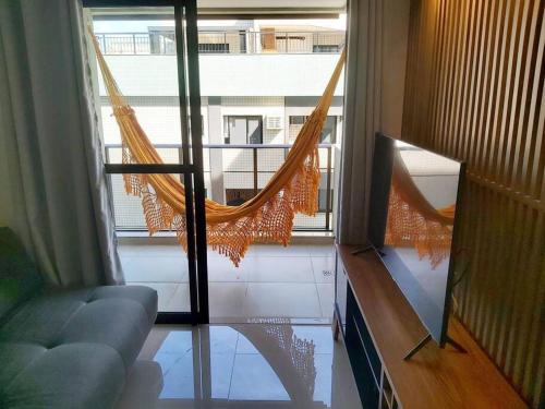 a hammock in a room with a view of a building at Rio De Janeiro Freguesia Jacarepaguá Lotf in Rio de Janeiro