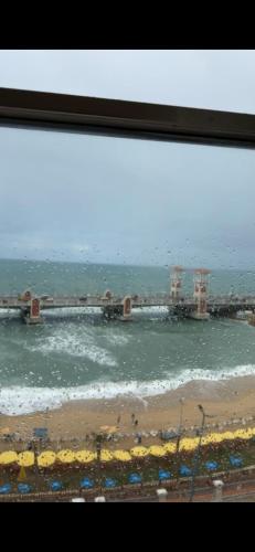 a view of the ocean from a window at Hyat Apartments in Alexandria