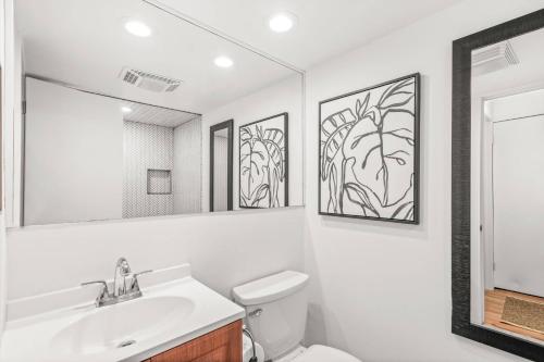 a bathroom with a sink and a toilet and a mirror at Chateau Roaring Fork Condo 31 in Aspen