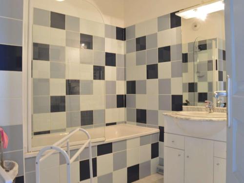 une salle de bain avec une baignoire, un lavabo et un miroir dans l'établissement Appt avec Terrasse, 2 Ch, Parking, à Saint Pierre la Mer - FR-1-229D-48, à Fleury