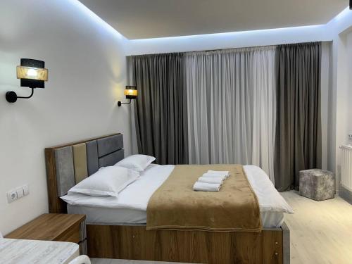 a bedroom with a large bed with towels on it at Hotel Peak in Gudauri