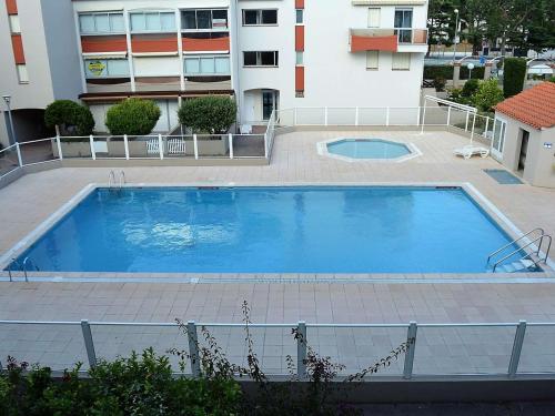 une grande piscine devant un immeuble dans l'établissement Studio/Mezzanine Climatisé 4 Pers. à 100m Plage avec Piscine et Parking – Argelès-sur-Mer - FR-1-225-707, à Argelès-sur-Mer