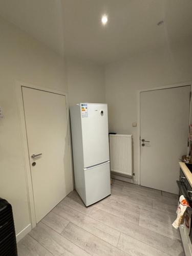 a kitchen with two doors and a refrigerator at Voske2 in Ghent