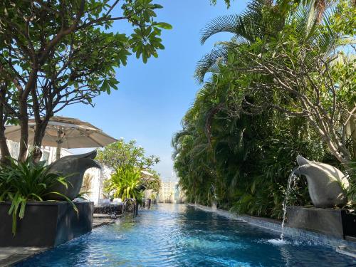 a pool at a resort with a fountain at The Ritz-Carlton, Bangalore in Bengaluru