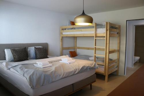 a bedroom with a bunk bed with towels on it at Lorez 5D by Arosa Holiday "neu renoviert" in Arosa