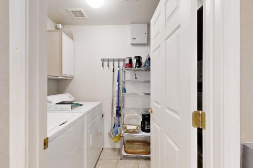 a kitchen with white cabinets and a white sink at Rancho Vistoso #256 in Tortolita