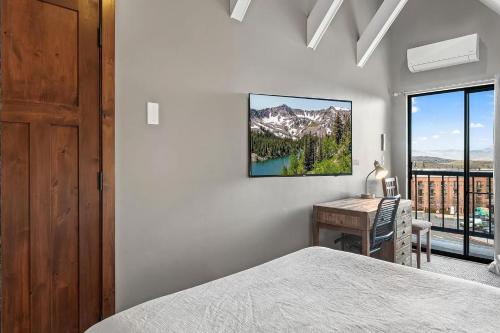 a bedroom with a bed and a desk and a window at Slope-Side Serenity Ski-In Ski-Out Gem with Pool in Park City