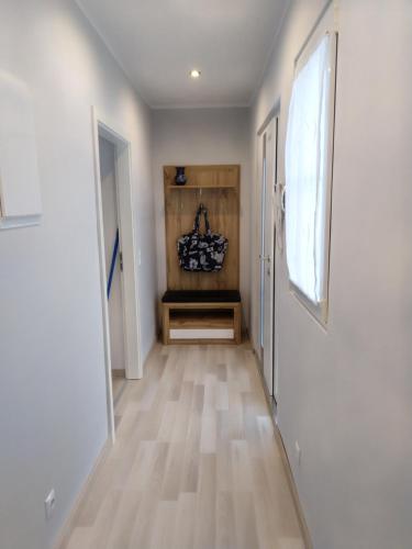 a hallway with white walls and wooden floors at neutal-ferienapartments in Neutal