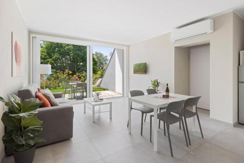 a living room with a couch and a table at Residence Conca Verde 2 with pool in Trarego Viggiona