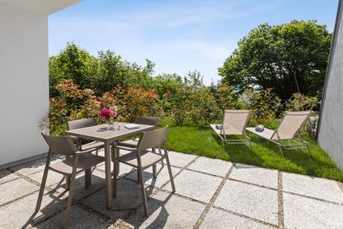 a table and chairs sitting on a patio at Residence Conca Verde 2 with pool in Trarego Viggiona
