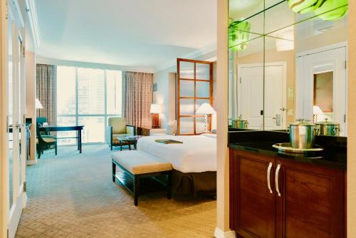 a hotel room with a bed and a bathroom at Strip View Suites - No Resort Fee ! in Las Vegas