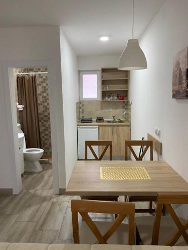 a kitchen and dining room with a wooden table at Smestaj Milovanovic in Soko Banja