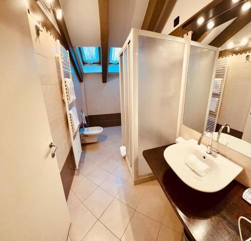 a bathroom with a sink and a shower at MOTEL Malpensa INN & Hotel-Airport in Case Nuove