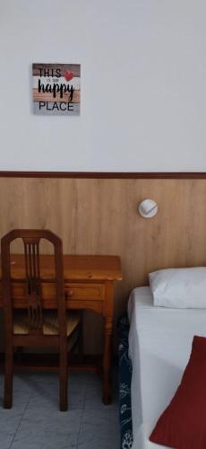 a bedroom with a desk next to a bed and a table at Suite Tati in Las Palmas de Gran Canaria