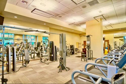 a gym with rows of treadmills and machines at Strip View Suites - No Resort Fee ! in Las Vegas