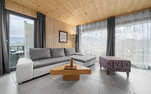 a living room with a couch and a table at Aparthotel Zell am See (Contactless Check-In) in Zell am See