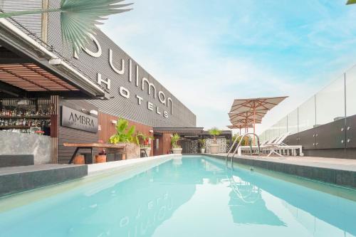 a swimming pool in front of a building at Pullman Lima Miraflores in Lima