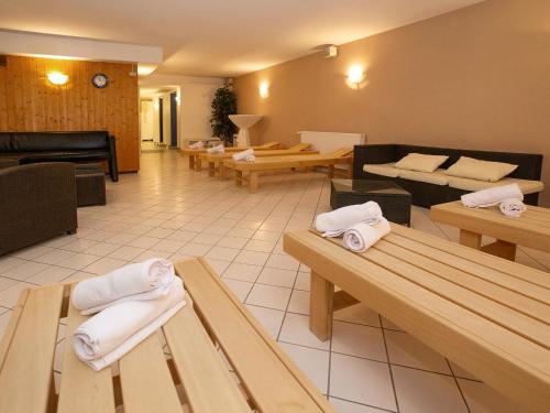 a restaurant with tables and chairs with towels on them at Hotel Am Gorzberg Greifswald in Greifswald