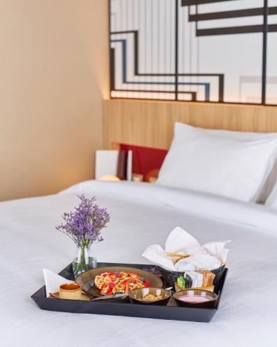 a tray of food sitting on top of a bed at Pullman Lima Miraflores in Lima