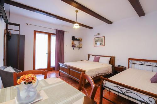 a hotel room with two beds and a table and a room at AMA Guest House in Turda
