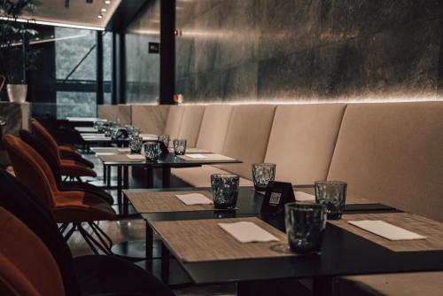 a row of tables and chairs in a restaurant at Pullman Lima Miraflores in Lima