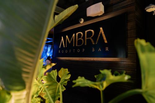 a sign for anarma rooftop bar with plants at Pullman Lima Miraflores in Lima
