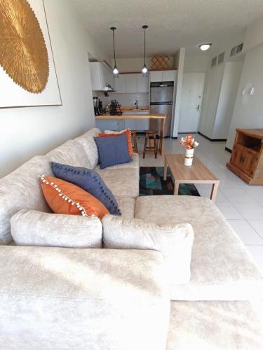 a living room with a couch and a kitchen at LagunaSuite & More in Porlamar