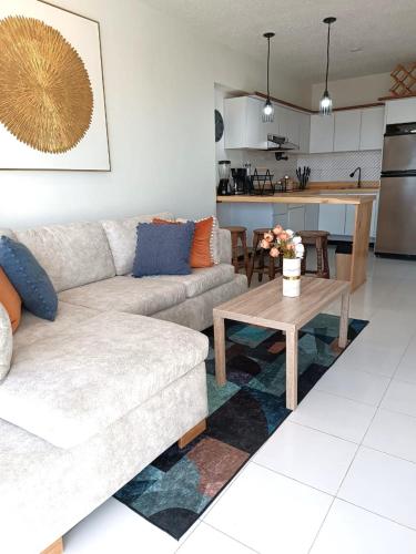 a living room with a couch and a table at LagunaSuite & More in Porlamar