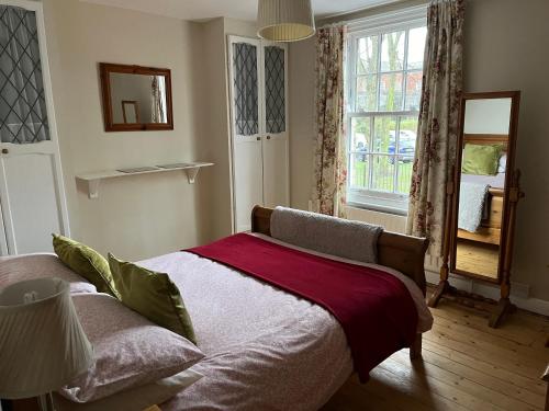 a bedroom with a bed and a large window at 5 Union Road in Lincoln