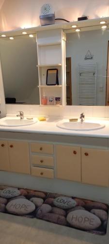 a bathroom with two sinks and a large mirror at Saint Georges 