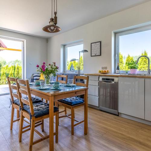 a kitchen and dining room with a table and chairs at Seaview House with fireplace in Puck