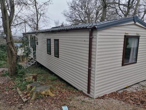 ein weißes winziges Haus im Wald in der Unterkunft Victory - idyllic holiday home in Hastings in Hastings