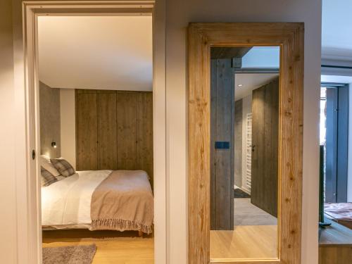 a bedroom with a bed and a mirror at Appartement Val-d'Isère, 3 pièces, 4 personnes - FR-1-694-326 in Val-d'Isère