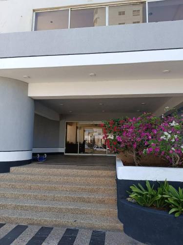 a building with some flowers in front of it at LagunaSuite & More in Porlamar