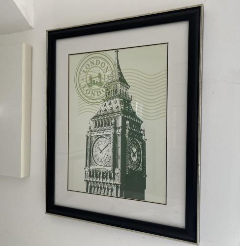 a framed picture of the big ben clock tower at San Clemente Residence in Gramado
