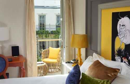 a hotel room with a bed and a balcony at Aria Hotel Budapest by Library Hotel Collection in Budapest