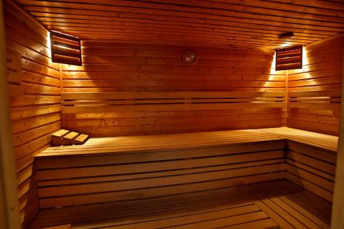 a sauna with a bench in a wooden room at Adina Apartment Hotel Budapest in Budapest