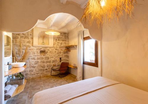 a bedroom with a bed and a sink in a room at Masia Aubareda in San Martín de Tous