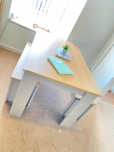 a wooden table with a plant on top of it at The Cwtch, Log Fire, Sleeps 6, Nr Zip World, Brecon and Bike Park Wales in Aberdare