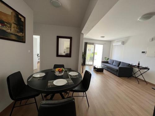 a living room with a table and chairs and a couch at Prince Boutique Apartment/1BR in Nicosia