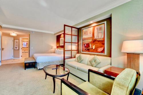 a hotel room with a couch and a bed at Strip View Suites - No Resort Fee ! in Las Vegas