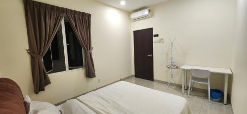 a bedroom with a bed and a desk and a window at La Belle Maison 12 @ Gurney Kelawai/Pulau Tikus/Georgetown in George Town
